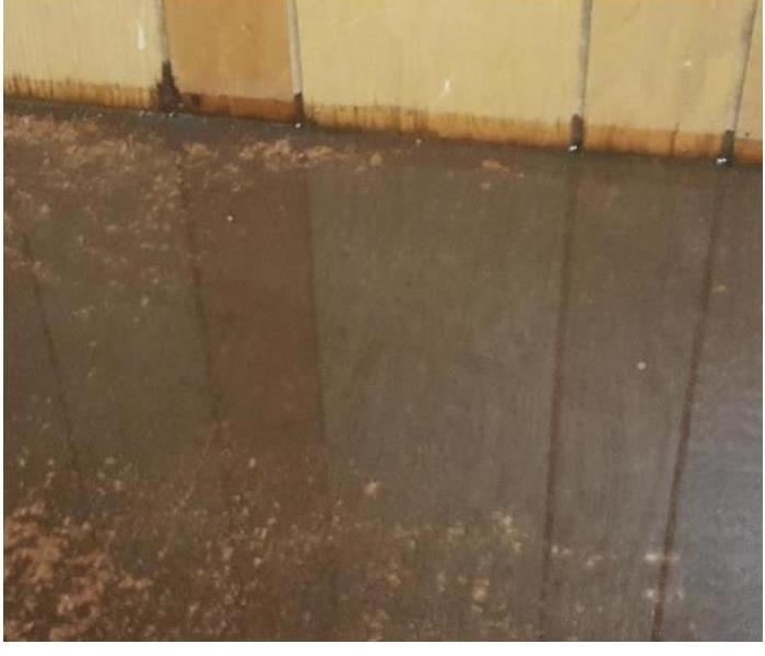 concrete floor with water pooled on the floor