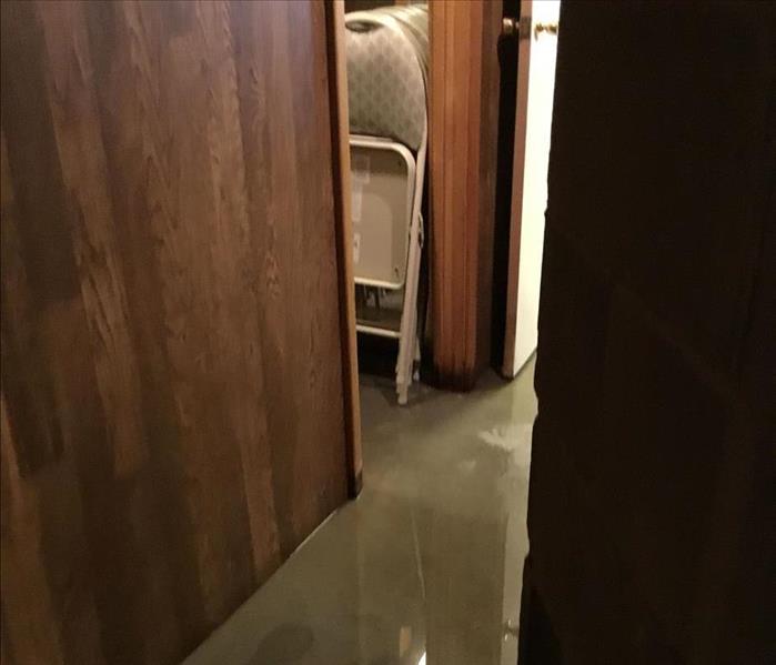 Standing water in a finished basement hallway