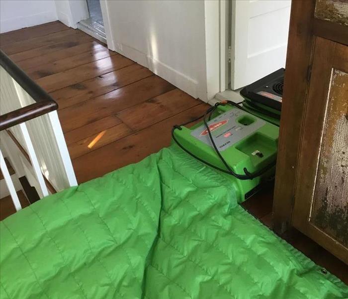SERVPRO green floor drying mat implemented next to stackable air mover