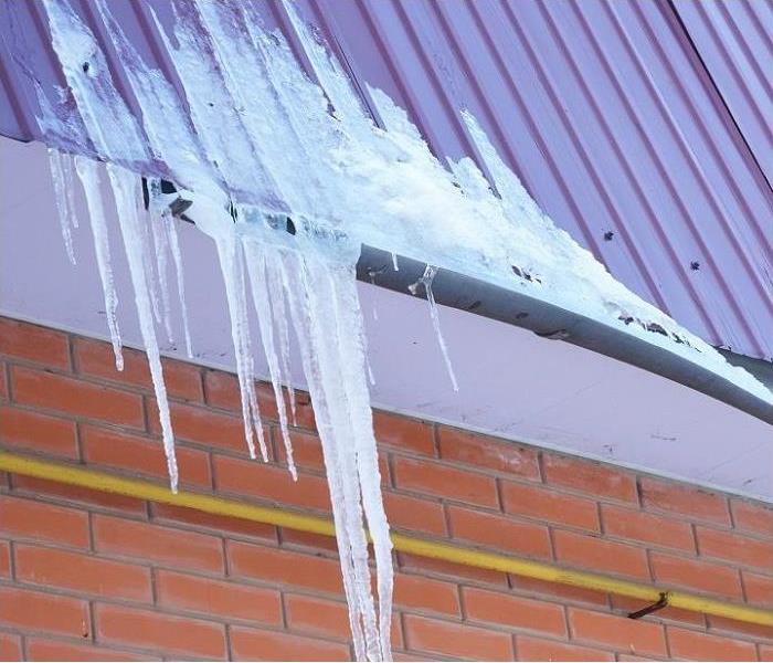 frozen water in rain gutter; ice on roof